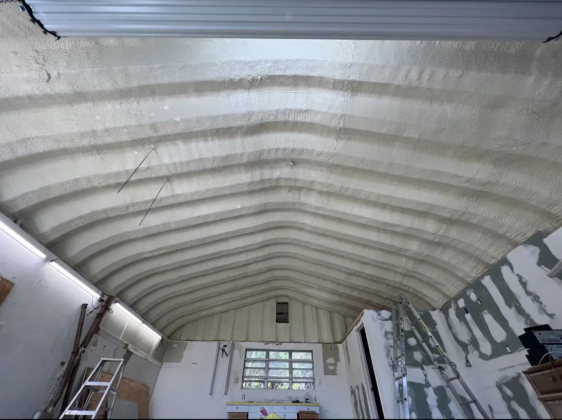 Spray polyurethane foam applied to the underside of a metal roof deck in Black Mountain